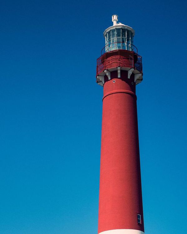 Barnegat Lighthouse on Long Beach Island against a blue sky